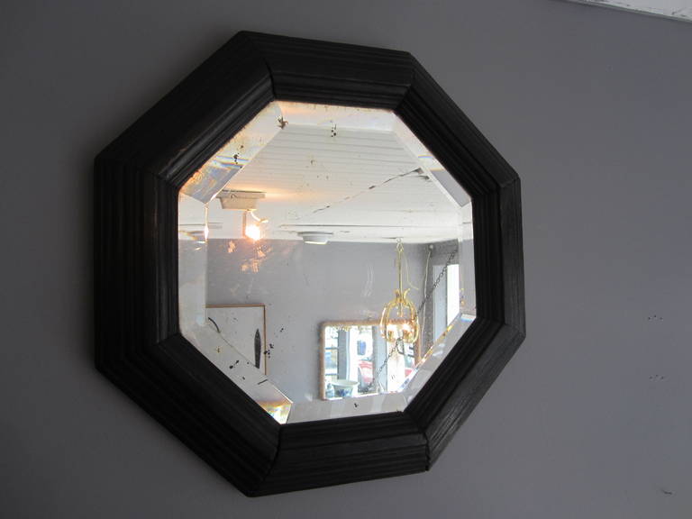Black painted octagonal mirror.