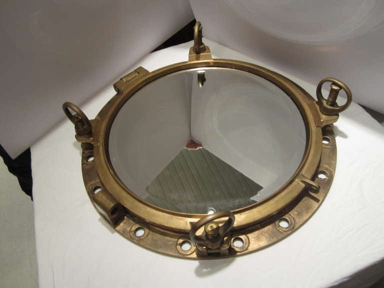 Ship's brass porthole fitted with beveled mirror.....solid brass