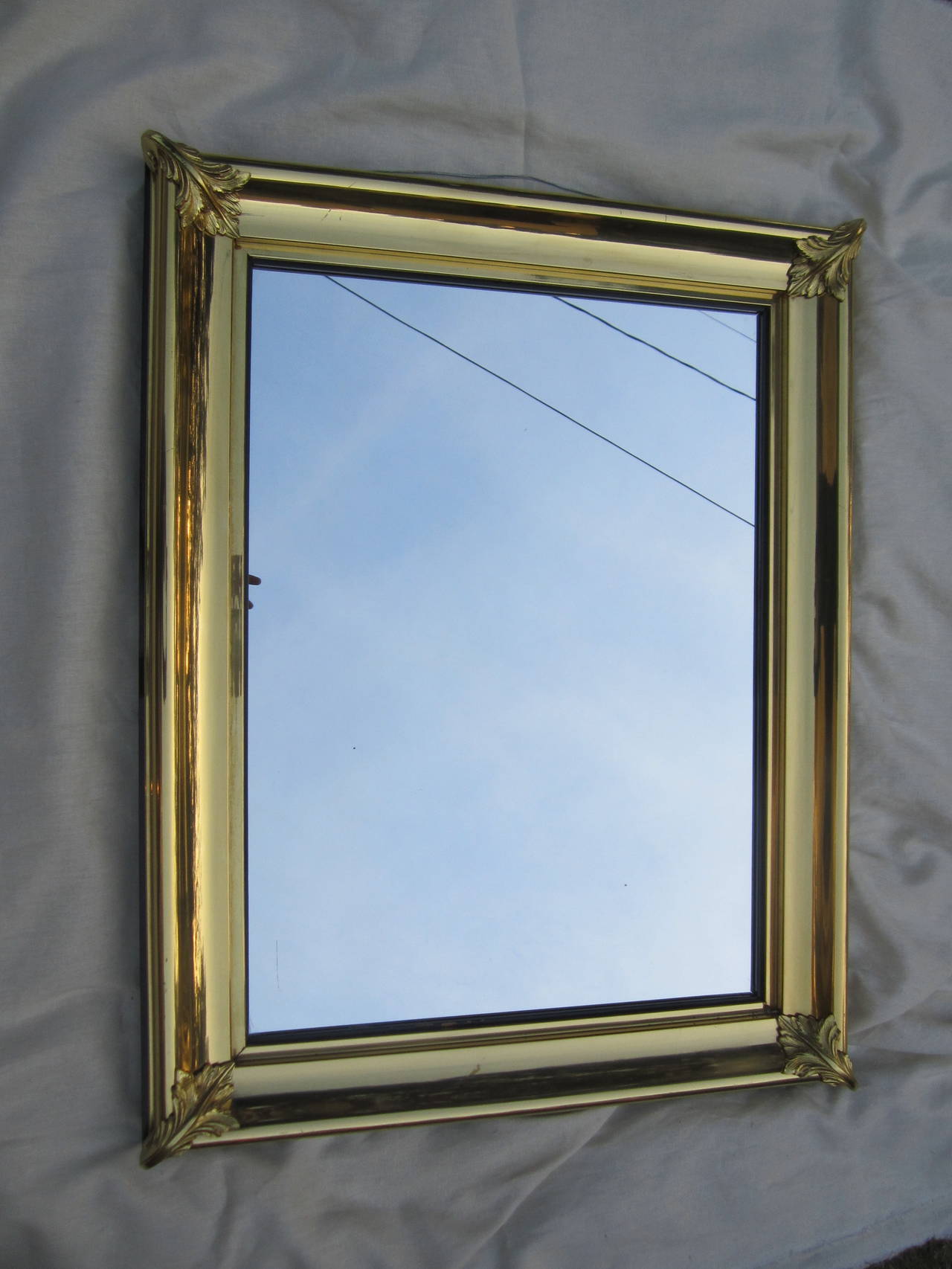 Handsome brass framed mirror with decorative acanthus leaves at corners.....