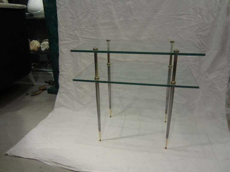 Pair of modern Italian brass and steel legged table with two-tiered glass. Fontana Arte style.