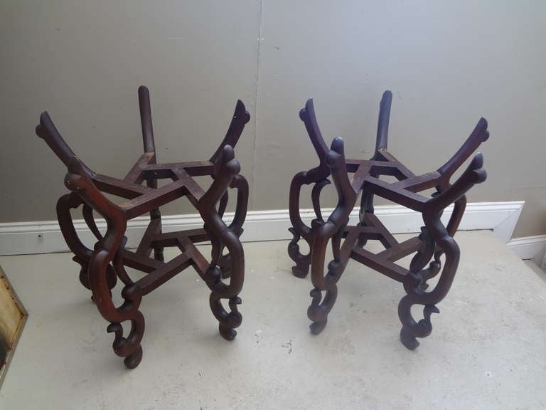 A well made pair of early to mid 20th century Chinese hardwood , probably teak , Chinese fishbowl stands ; surely destined to be a pair of tables with either glass or stone tops. A good size and wonderful design.