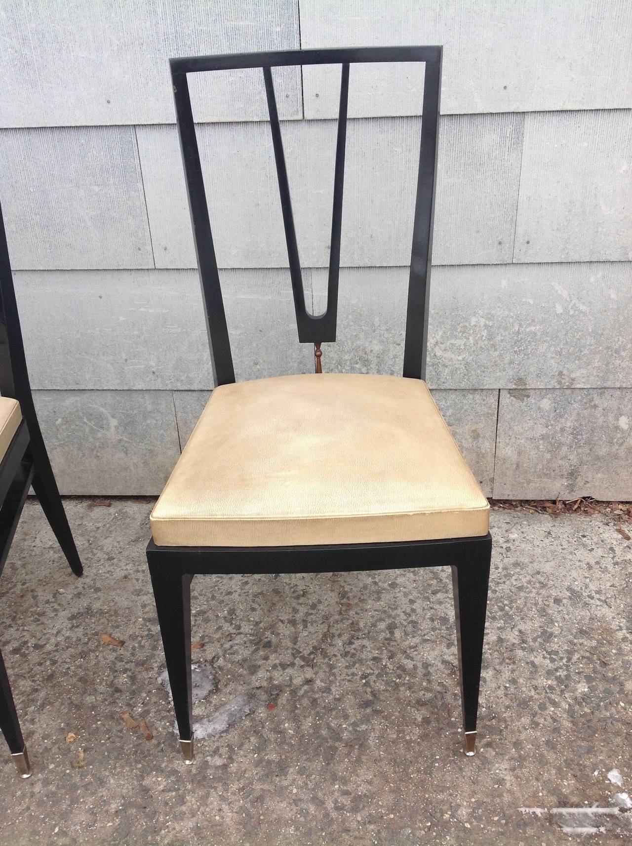 A very chic set of six mid-20th century (1950s or early 1960s) ebonies dining chairs with brass detail on the back, probably Italian but unmarked.