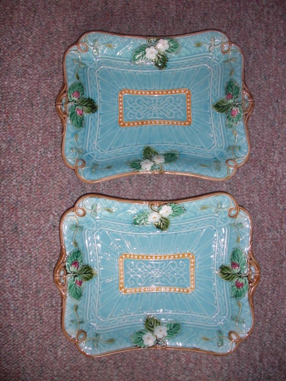 A pretty pair of circa 1870 French Sarreguemines majolica strawberry platters / dishes with a turquoise background and a raised strawberry flower and strawberry motif.