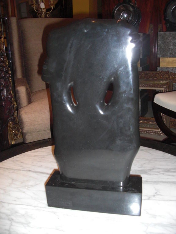 Black marble abstract sculpture in the form of a primitive art mask? by Catherine Catchi Childs dated 1972. See our other listing for some info on the artist.