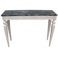 A neoclassical style marble top console