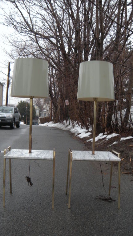 A very handsome pair of mid 20th century marble top and metal floor lamps. The height given below is just to the top of the brass fixture or socket and doesn't include the upside down milk glass shades or the shades.