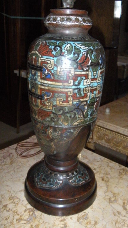 A hard to find turn of the century Chinese cloisonne lamp with matching cloisonne reticulated bronze shade. We certainly don't want to oversell our things but this sort of lamp with the matching shade are far less common than other big name lamp
