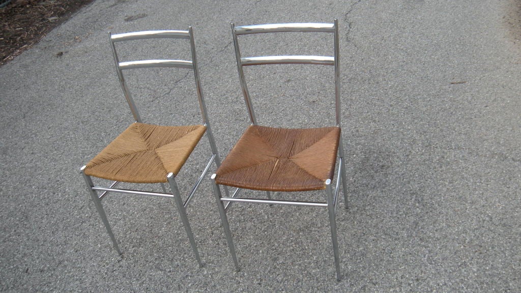 A quality pair of vintage (circa 1960's ) chromed side chairs with rush seats.... in the style of Gio Ponti. Original decal 