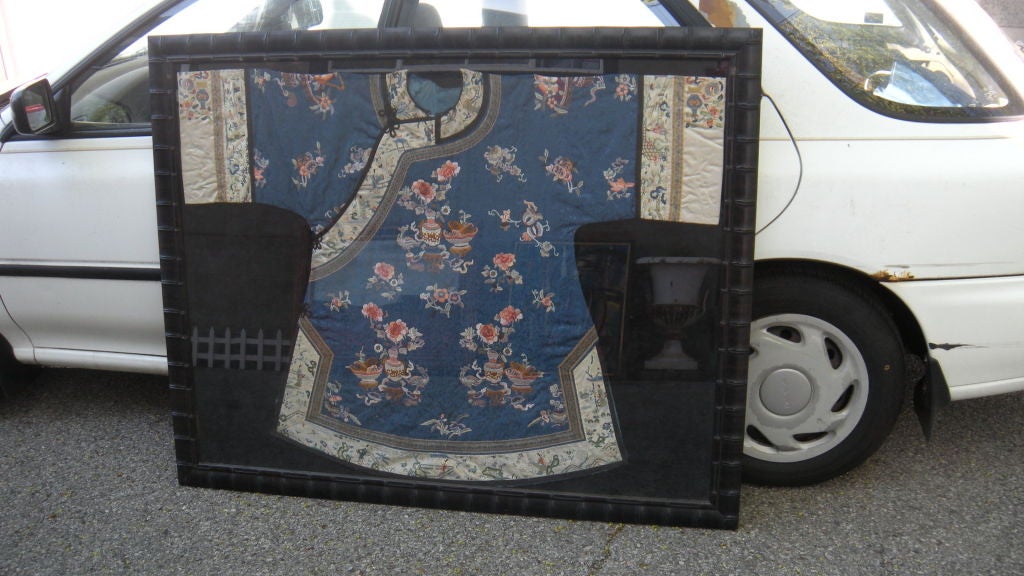 A semi antique or more likely antique Chinese hand embroidered silk robe.  Framed under glass sometime in the 1980's.