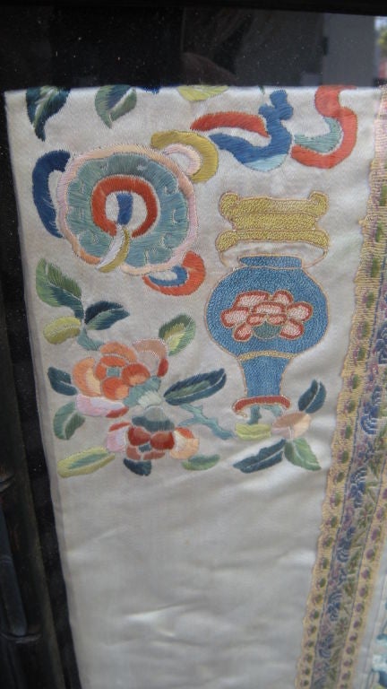 Chinese embroidered silk robe under glass 1