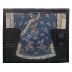 Chinese embroidered silk robe under glass