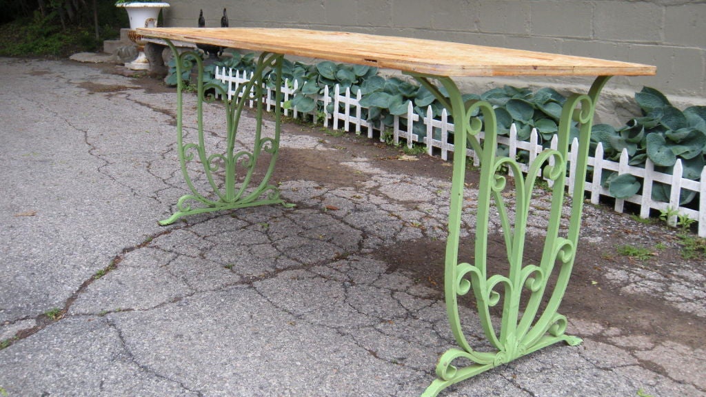 A very good quality heavy guage 30's wrought iron table. Although found here it is almost surely French although that is not so important to us , the quality is more important.Several coats of paint history . Please note the matching pair of benches