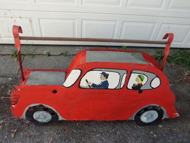 A large 3 dimensional vintage folk art painted metal sign in the form of a taxi. Originally a neon sign but the glass tubing was very damaged so we removed it.It appears to made of galvanized metal. Quite heavy. We are not positive of the origin of