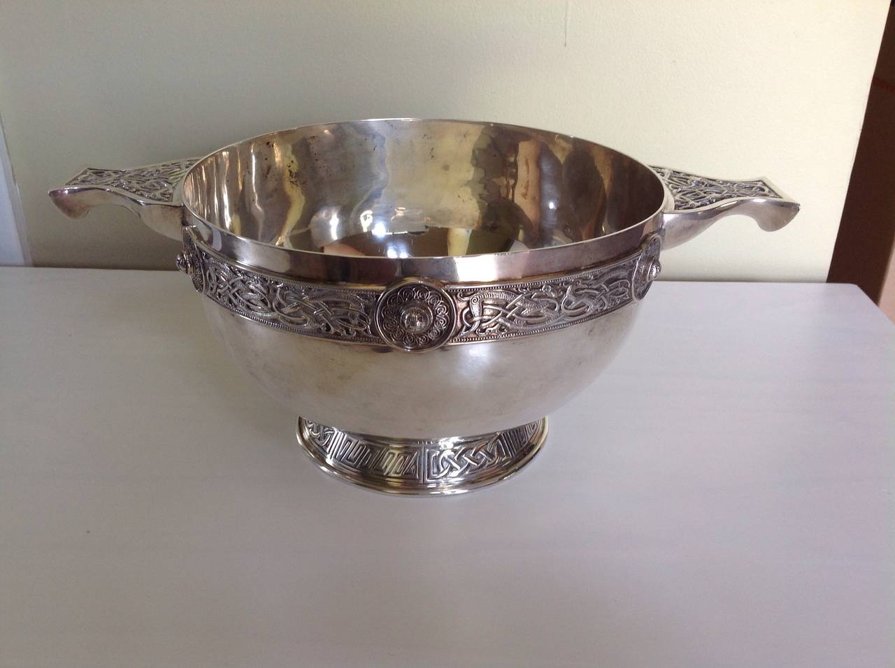 A large, unusual and very handsome English Sterling silver bowl of beautiful proportions decorated in the Celtic style, made in London in 1906 by James Wakeley and Frank Clarke Wheeler, which later became 