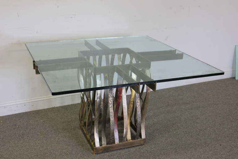 A stunning iron, brass, copper and steel table with glass top by Silas Seandel. Signed and dated 1978.