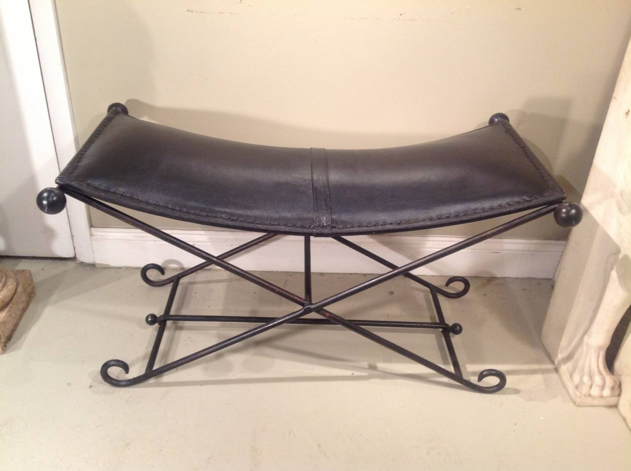 An unusual and nice quality 1950's wrought iron and leather folding bench, probably French.