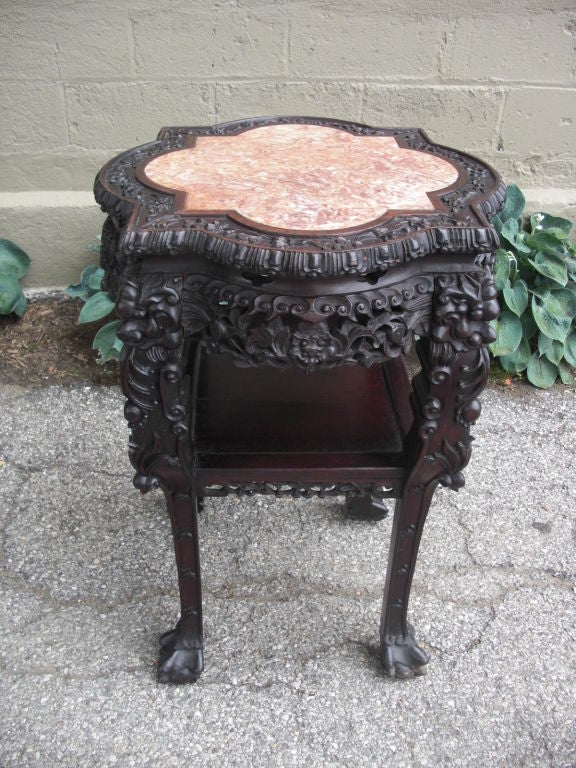 A great carved Cinese hardwood stand with inset marble top