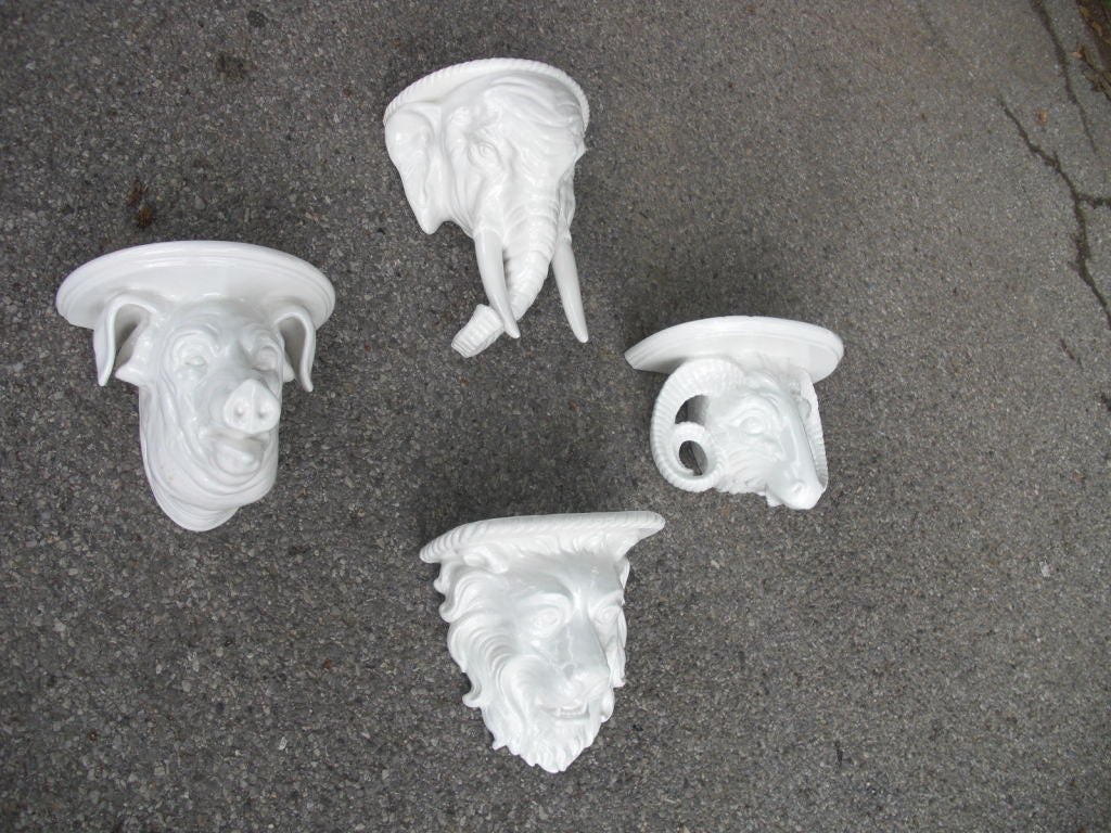 A set of 4 vintage Italian ceramic figural wall brackets with animal heads (an elephant, a pig, a ram and a lion). A very decorative set of brackets. Stamped made in Italy and with a maker's mark ( an inverted 
