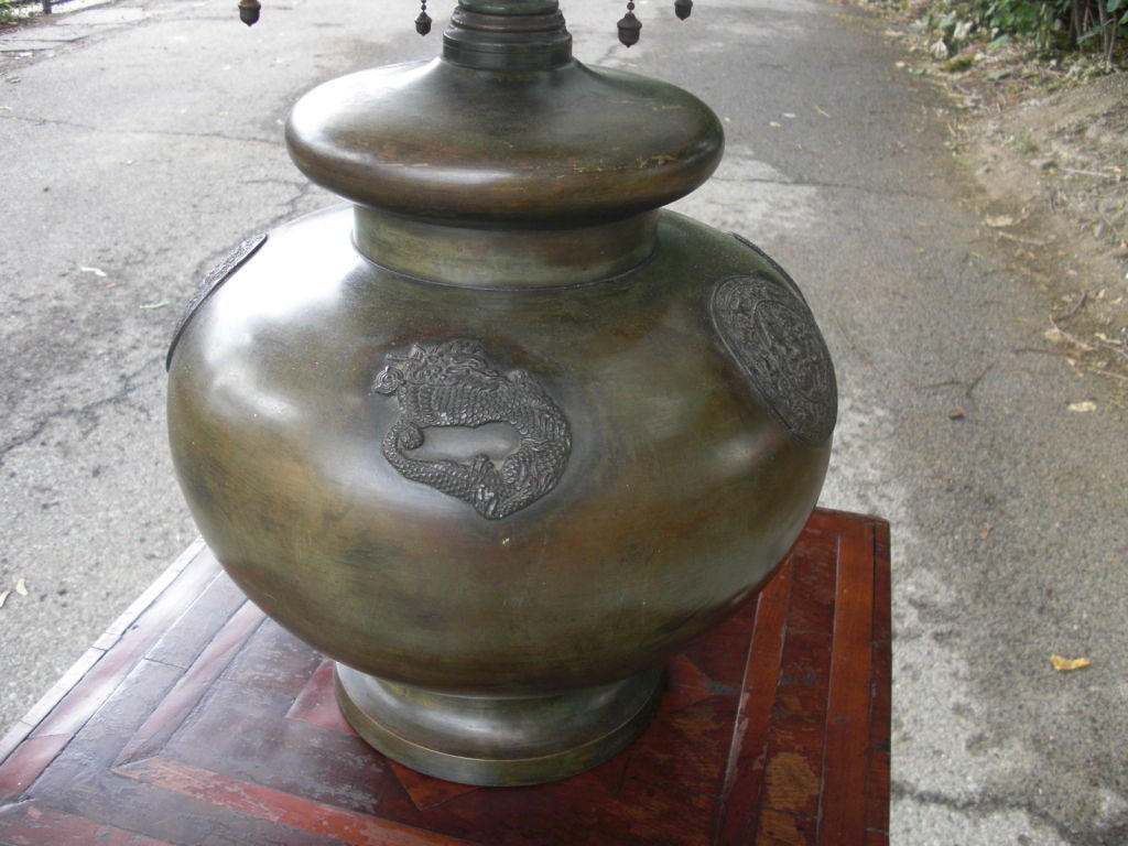 A large and beautiful American patinated bronze archaic asian style table lamp. Terrific quality with sophisticated green patina and casting details, as shown in the detail photos. It has a quality 