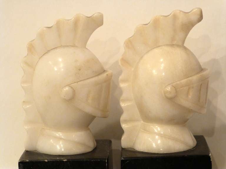 Pair of carved marble Roman Helmet Bookends on marble bases.
Italy.  First half of the 20th-Century.