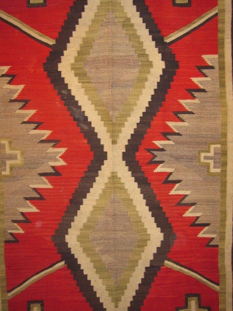 Navajo Rug.  Circa 1920.  Southwestern USA.  Tightly woven flat weave.  Extremely unusual vegetable dyed green wool accents give this rug an added graphic dimension.