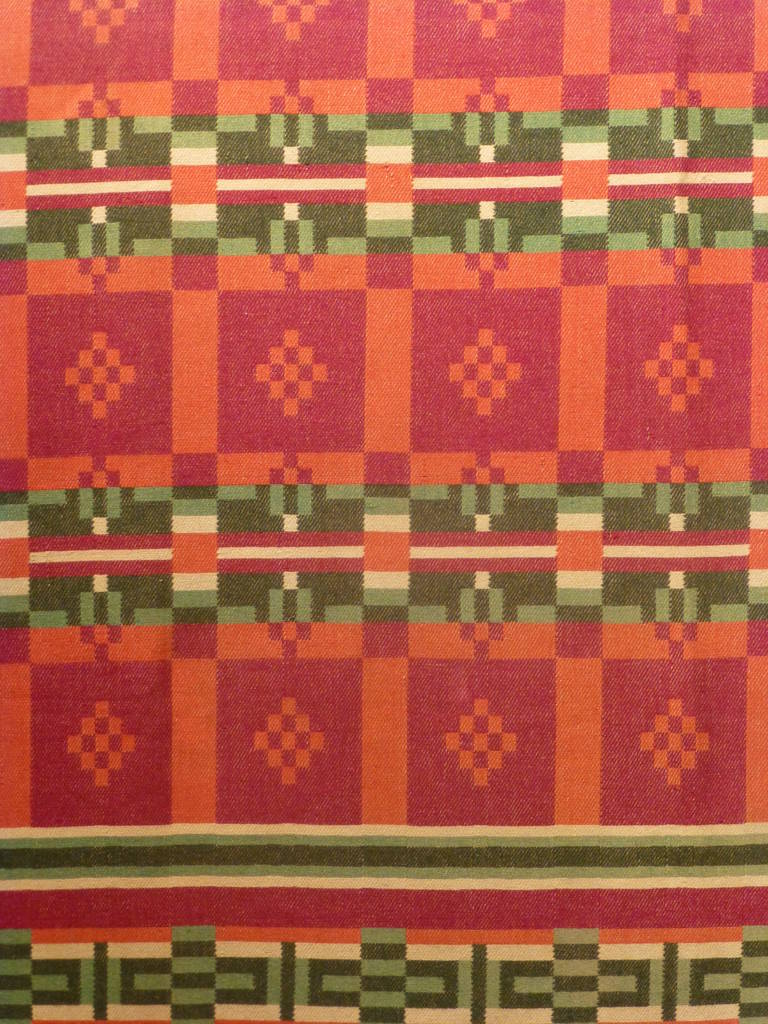 Vintage wool horse blanket.  Bold geometric design in beautiful shades of red and green with beige. The blanket is reversible, with dark and light tones of red and green on each side.  The blocks are reminiscent of the popular 