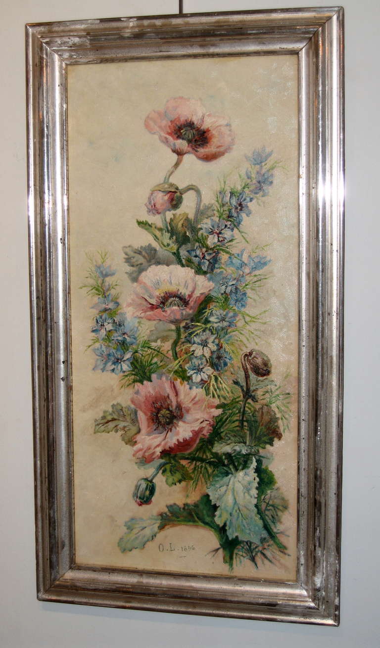 A beautifully executed oil on canvas of Poppies in an american silver gilt frame. Signed O.L and dated 1896.
