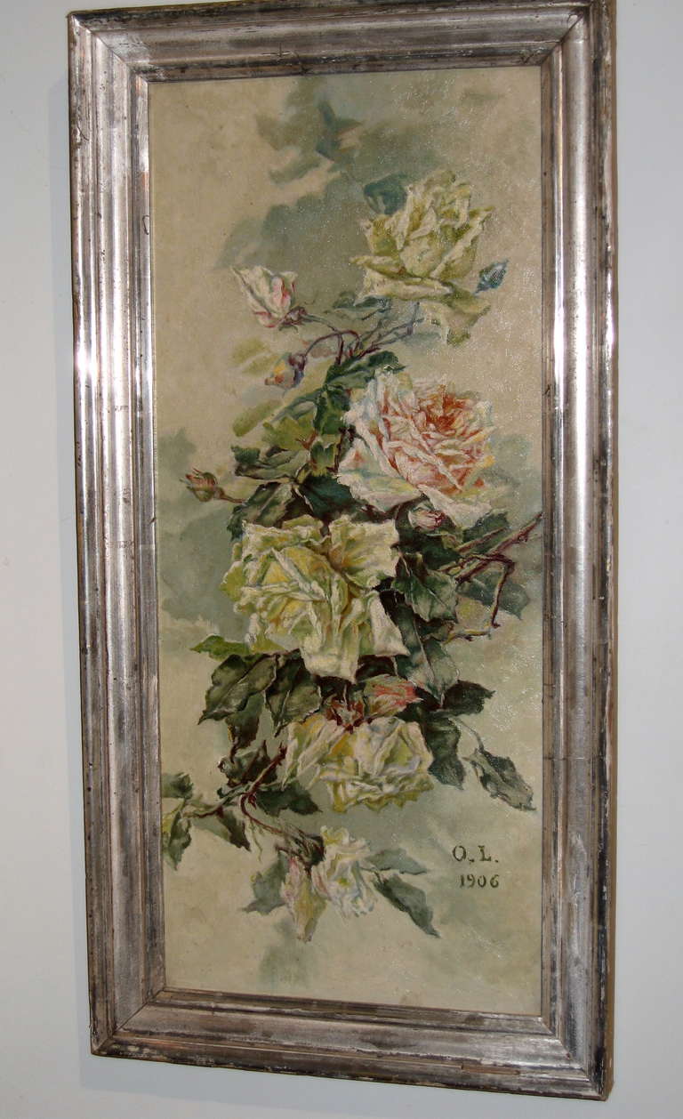 A well executed oil on canvas painting of Roses in a French silver gilt frame. Signed O.L and dated 1906.