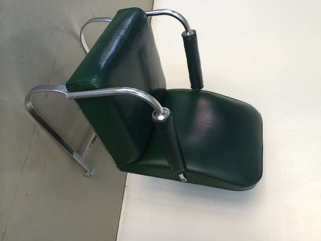 A classic Kem Weber Springer Chair for the LLoyd manufacturing Co. in Los Angeles CA. circa 1930, in original green vinyl with a small repair to the seat. Nice condition overall with some chrome loss on the back leg.