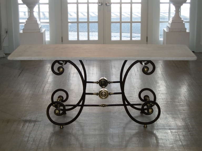 A French bakers work table with cast iron base and white marble top. This is probably one of the best examples we've seen. The marble top is long and very elegant , made with an extra thick slab of old marble. This allows the table to serve as a