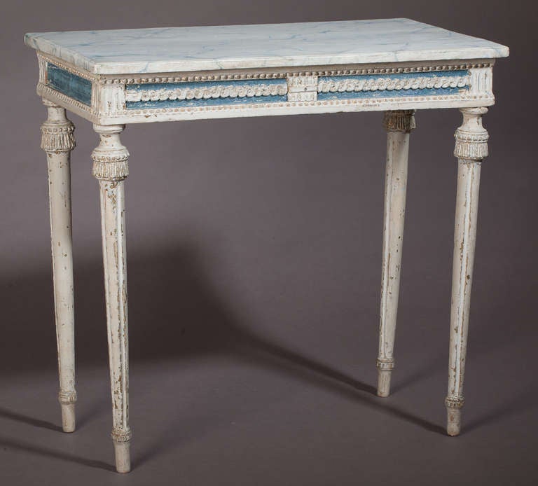 A Swedish, Gustavian period, console table in original blue and white paint, with refreshed faux marble top. The legs have carved 