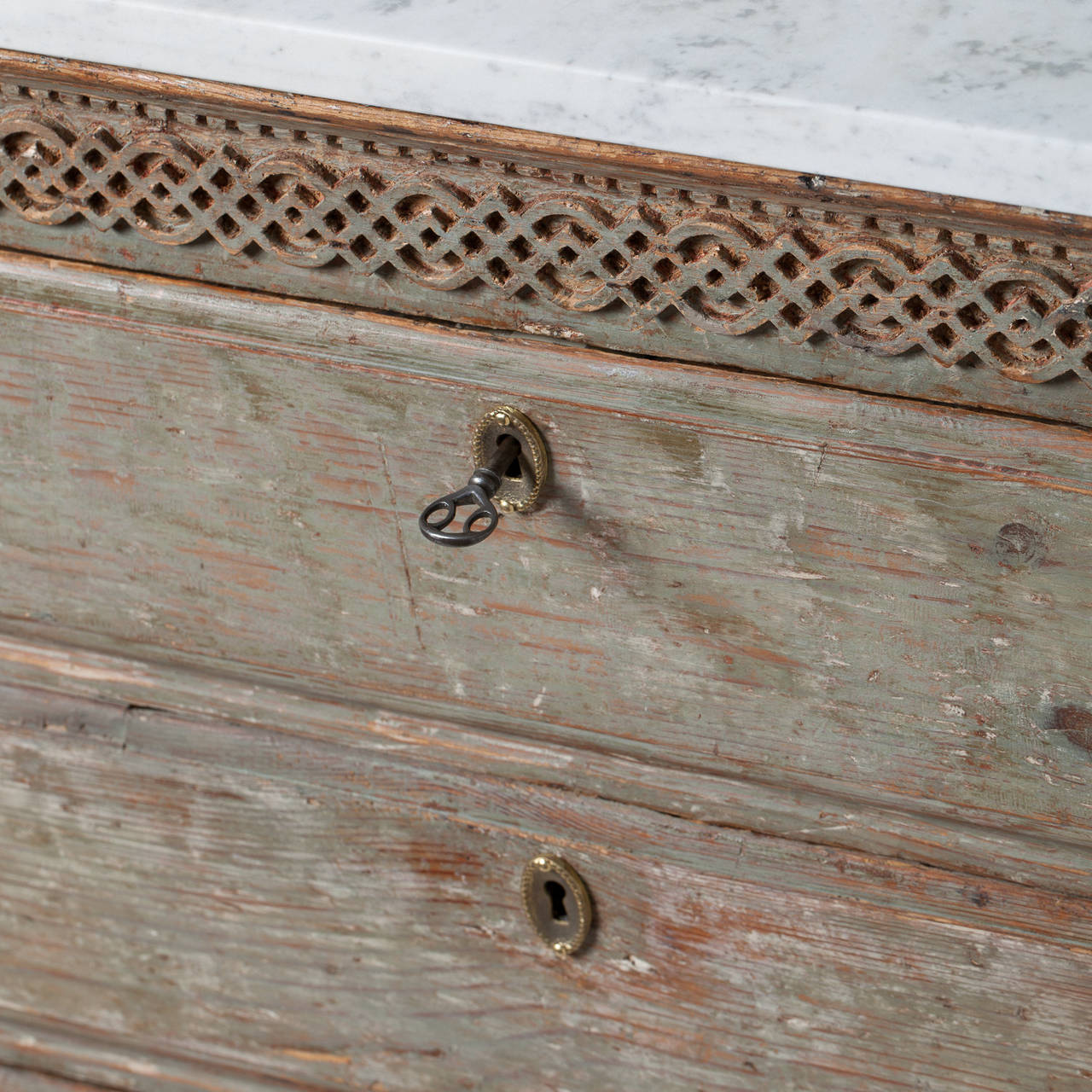 This charming three drawer Swedish chest has beautifully detailed carving on the front and curved fluted legs. The marble top is antique Swedish marble. It is a very useful piece that could go beside a bed or in an entryway or bathroom. The pale