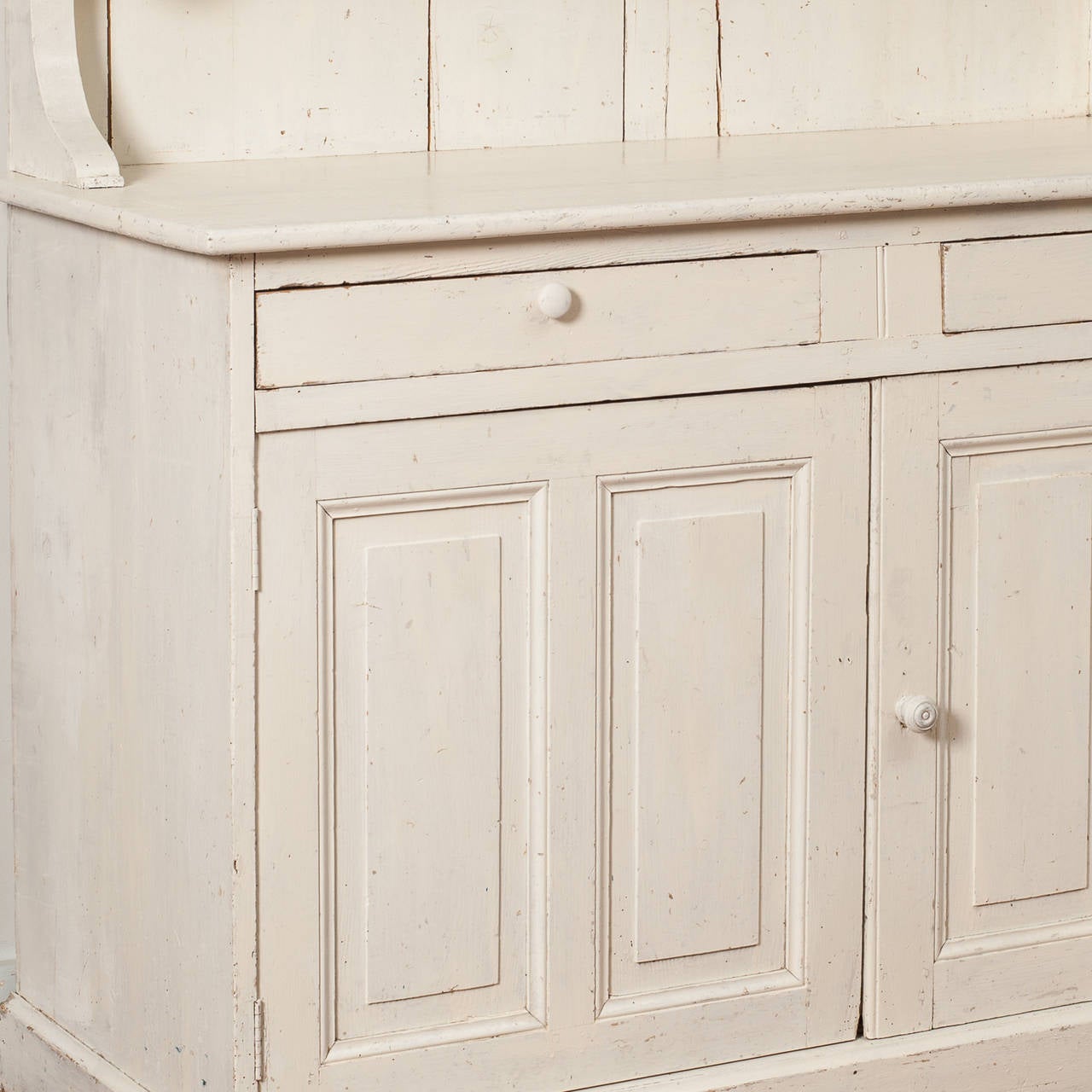 A French white painted country cupboard, circa 1900.
This is a great piece for a country kitchen or pantry with three shelves for display, and two cupboard doors beneath with two interior shelves for storage. The old white paint has been refreshed