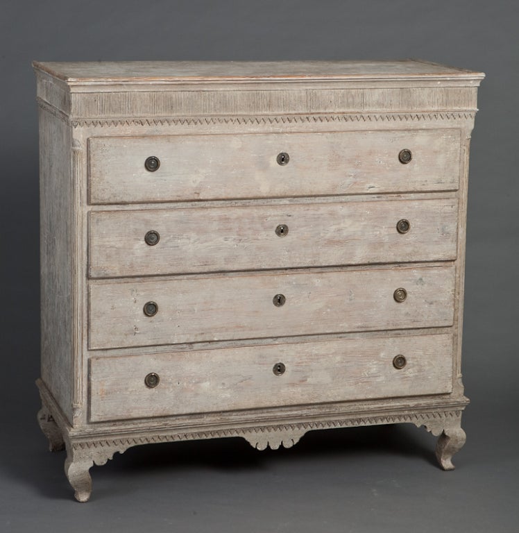 An elegant Swedish commode from the end of the Gustavian period circa 1800- 1815. The piece is made of pine with beautiful details in sculpted wood. Retains traces of original paint.