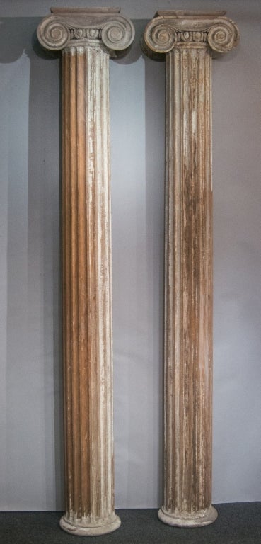 A pair of reeded Columns with Ionic capitals from Binghamton, NY. Traces of old (originally white) paint.