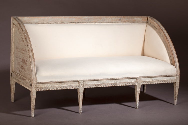 A Gustavian Period Settee in an unusual design with half curved sides. Beautiful details, and including large visable iron bolts. Newly upholstered in French linen.