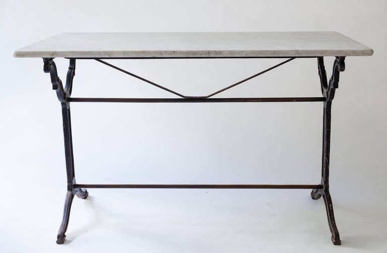This French marble top bistro table is great because of the size of the marble top. It is long enough to sit two on each side and two at the ends. It is wide enough to allow room for place settings on each side as well as items in the middle of the