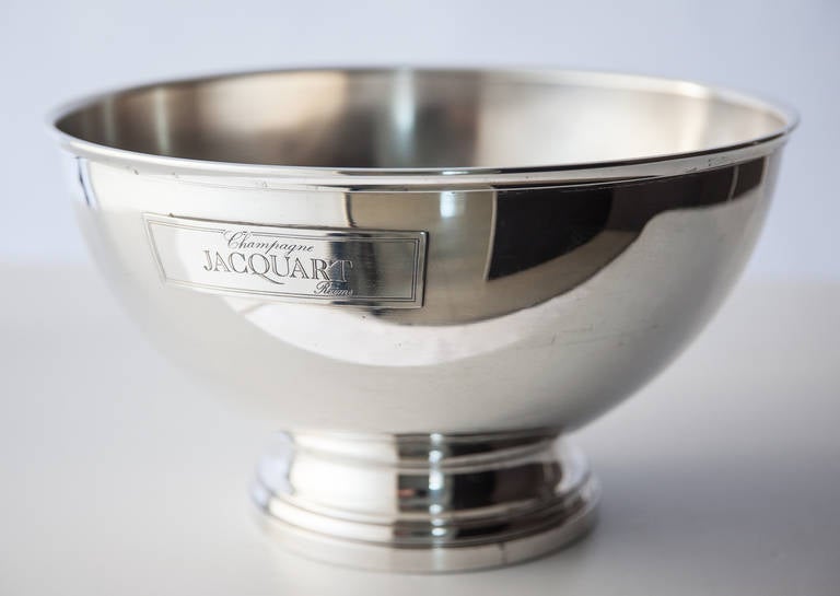 An elegant silver plate champagne cooler made for Champagne Jacquart, Reims. This piece is in perfect condition inside and out and has a plate bearing the name of the company, Jacquart. It stands on a footed base typical of the period.