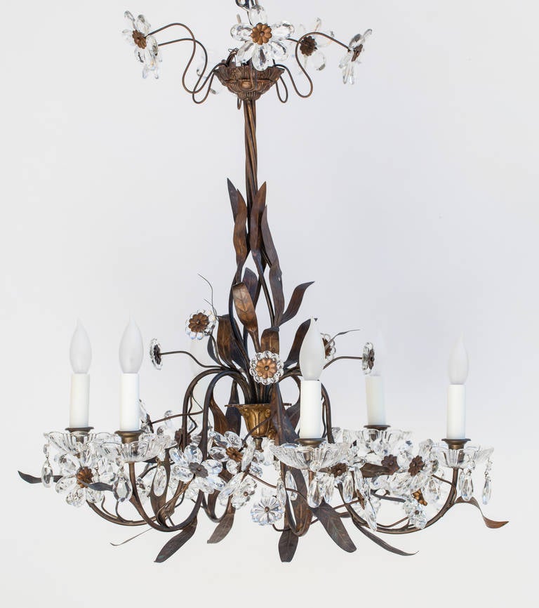 A very light and airy French chandelier with crystal flowers, smaller crystal rosettes and and a central core of bronzed leaves and twisted vines. This piece has been newly rewired for US circuits and has six lights with beeswax candle holders. It