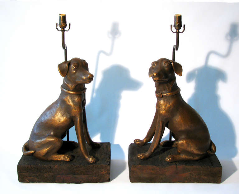 A large pair of ceramic Labrador Retriever sculptures with bronze patina finish, mounted on rustic stained wood bases. The lamps came from a private estate in Mexico City, circa 1950. Height measurement from the top of the finial to the base is 32