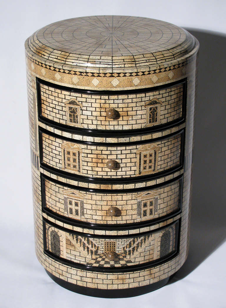 A small Fornasetti style lacquered architectural cabinet with four drawers.