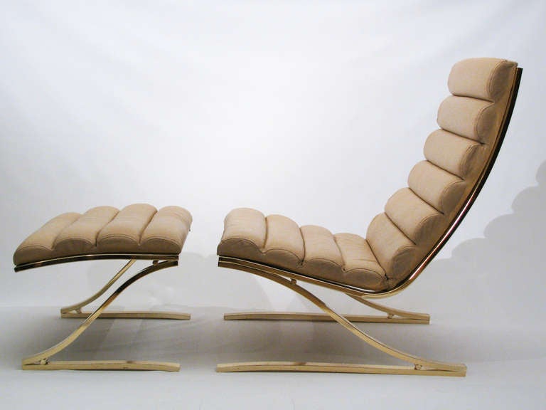 A sculptural leather and cantilevered brass lounge chair and ottoman by Design Institute of America, circa; early 1970”²s. This example is done in its original rolled and french-seamed creamy tan leather. Price is for the chair and ottoman. Lounge