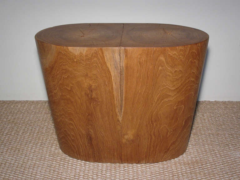 A solid teak table or stool in a oval shaped conical-form produced by Ironies in California, imported from Indonesia. We currently have (two) available.