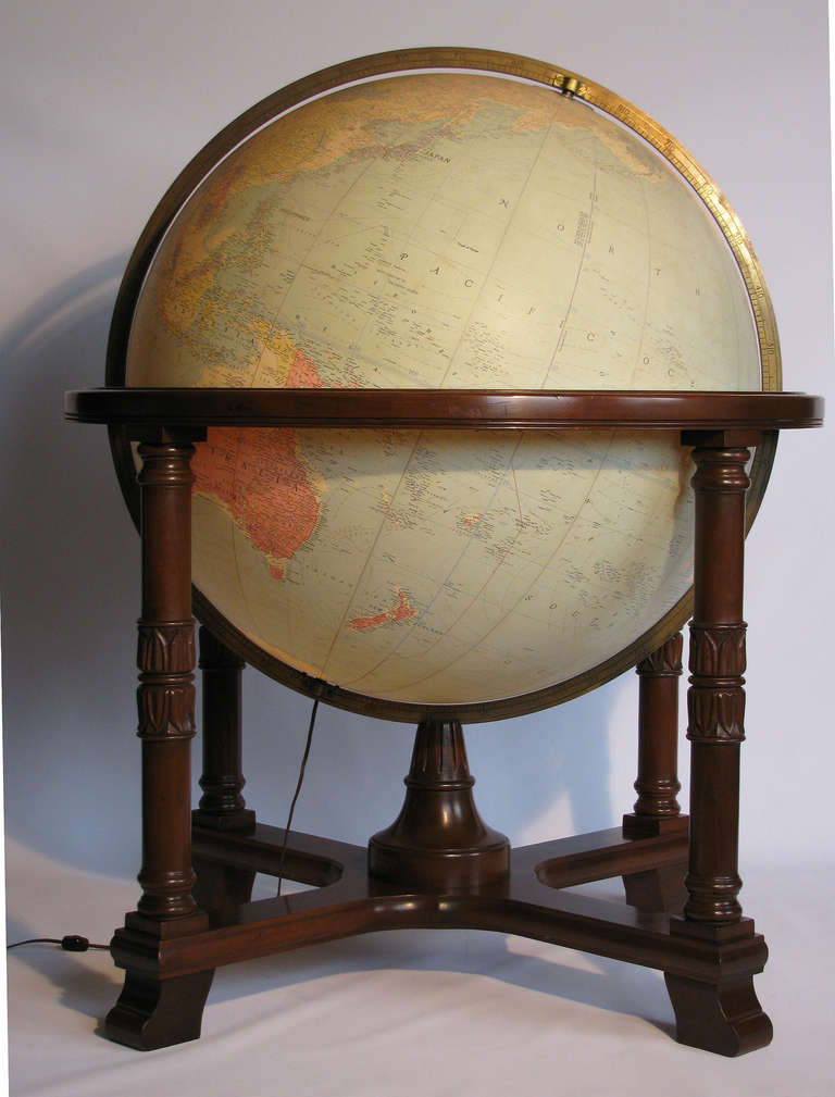A monumental Replogle terrestrial globe with neoclassic style base. The globe has an interior light with the on/off switch on the cord.