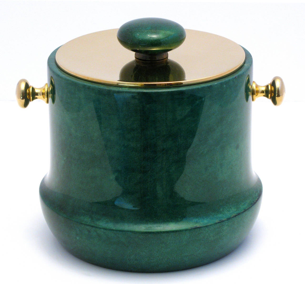 A Classic Italian ice bucket by Aldo Tura, of emerald color lacquered goatskin on wood; with polished brass lid and handles. The interior lining is black plastic.