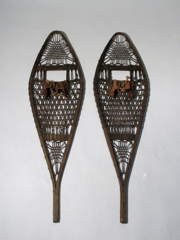 A pair of antique snowshoes manufactured by The Tubbs Snowshoe Co, Norway, Maine. This pair of snowshoes are a wonderful example of early American sporting gear equipment and will look perfect displayed in your adirondack cabin.