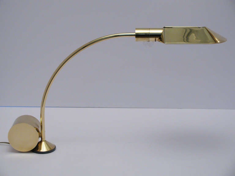 A stunning pair of brass counterbalanced table lamps by Cedric Hartman. Shade rotates 140 degrees around socket housing, base rotates 360 degrees. Lucite dimmer control. Signed and numbered at base; Cedric Hartman, Omaha Nebraska. Price is $5500.00