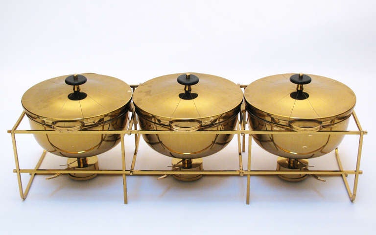 A triple chafing dish server on stand, complete set including three burners and flame snuffs. Marked Dorlyn Silversmiths.