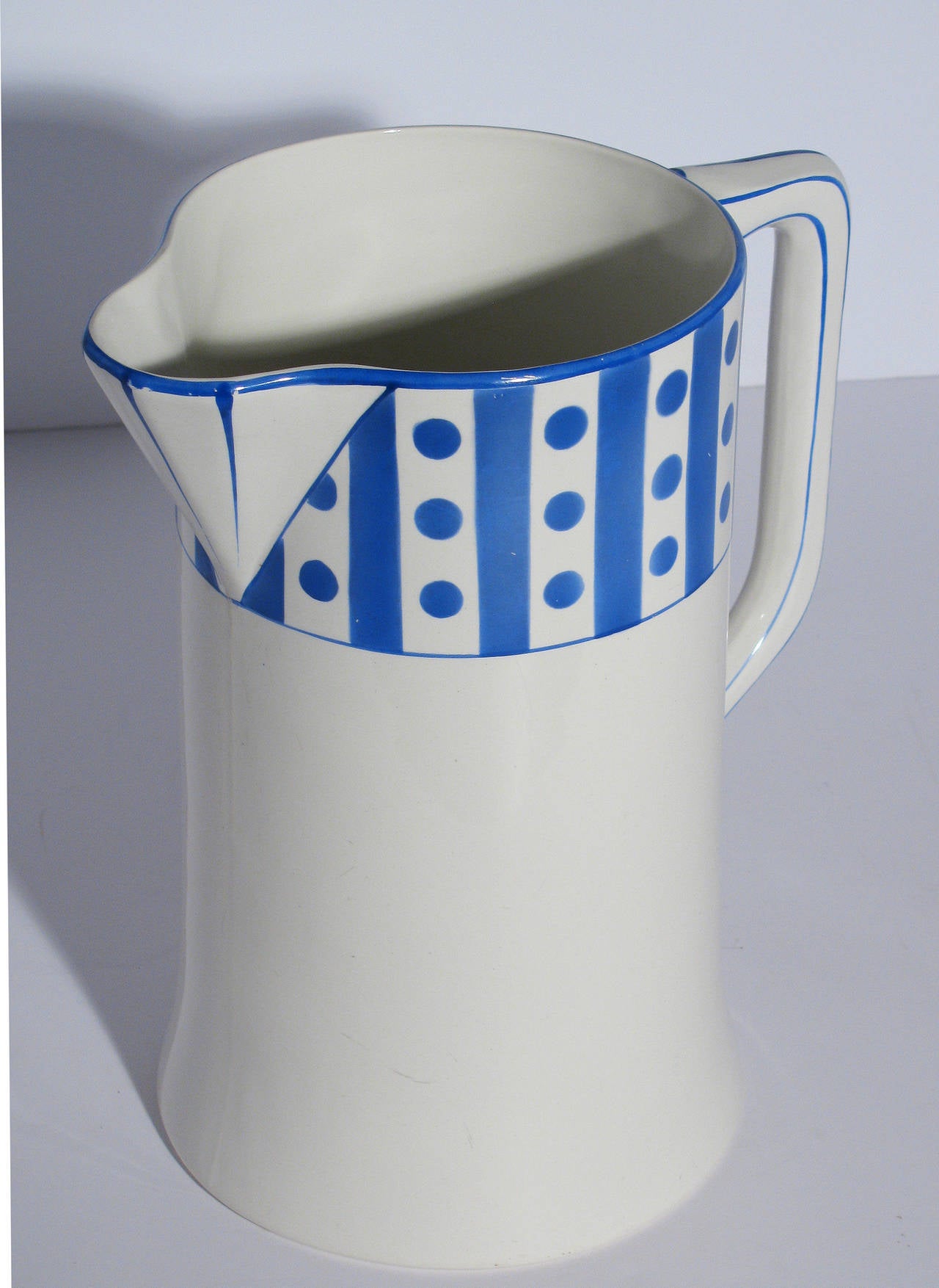 A large Belgian porcelain wash basin and pitcher set, white with French blue dot pattern. Signed at base; Manufacture Imperiale et Royale, made in Belgium. Hallmarked with a crown and NIMY. Pitcher measures: 11