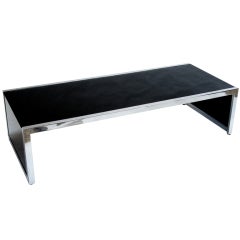 A Polished Aluminum & Glass Cocktail Table